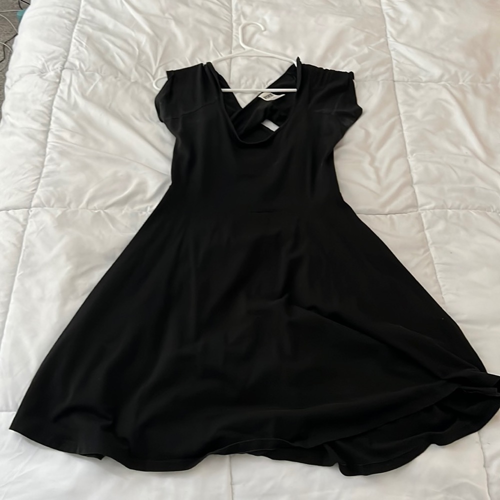 Black, mid length, medium, dress from PINK with a cross back.